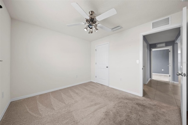 unfurnished bedroom with ceiling fan and carpet