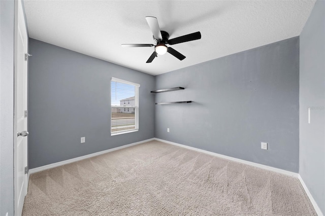 empty room with a textured ceiling, ceiling fan, and light carpet