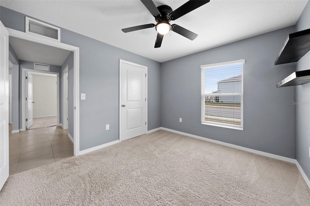 unfurnished bedroom featuring ceiling fan and light colored carpet