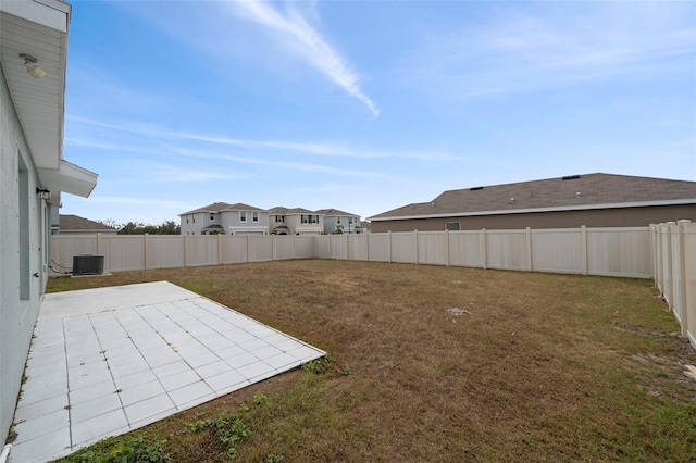 view of yard featuring central air condition unit and a patio