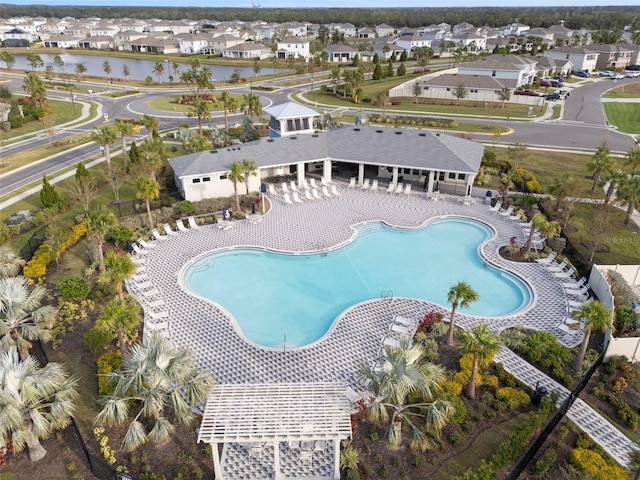 view of pool featuring a patio and a water view