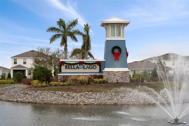 community sign featuring a water view