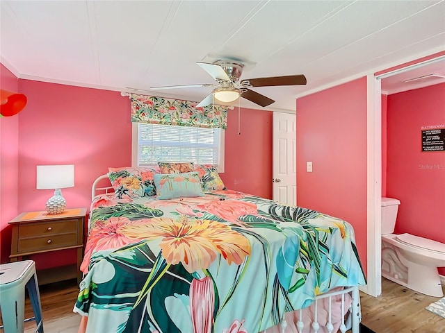 bedroom with connected bathroom, ceiling fan, and light wood-type flooring