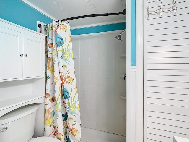 bathroom with a shower with curtain and toilet