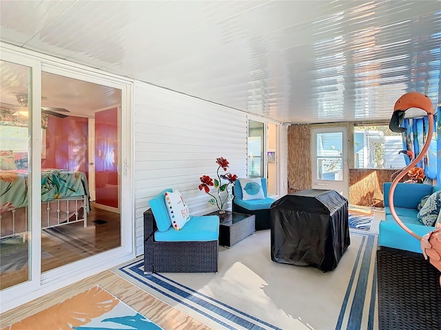 sunroom / solarium featuring ceiling fan