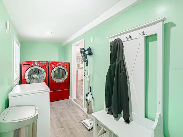 laundry room with washer and dryer and light hardwood / wood-style flooring