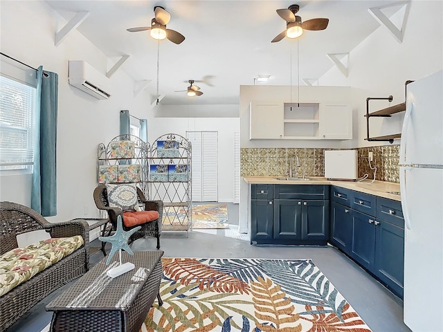 kitchen with sink, tasteful backsplash, white refrigerator, a wall unit AC, and blue cabinets