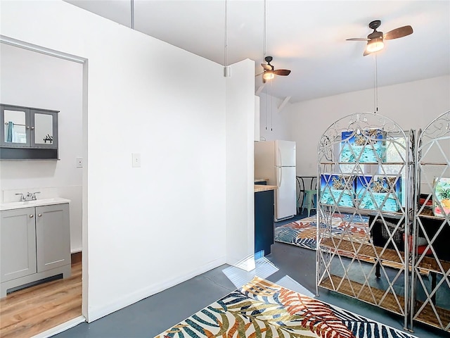 dining space with ceiling fan and sink