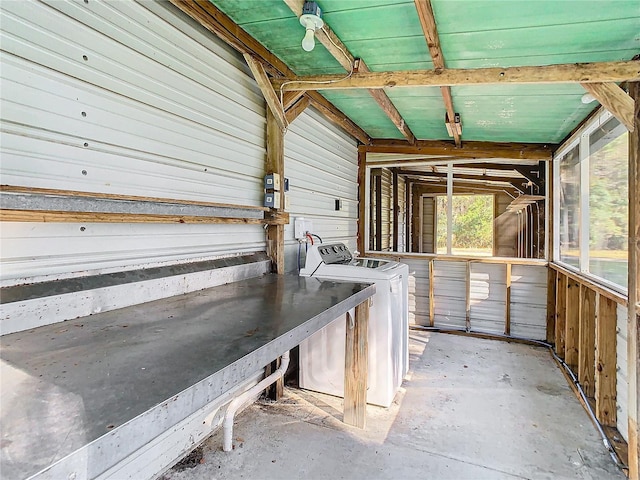 exterior space featuring washing machine and clothes dryer and wooden walls