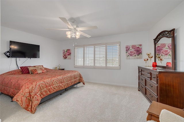 bedroom featuring light carpet, ceiling fan, and baseboards