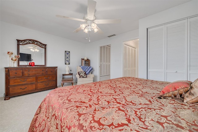 bedroom featuring light carpet, ceiling fan, and visible vents