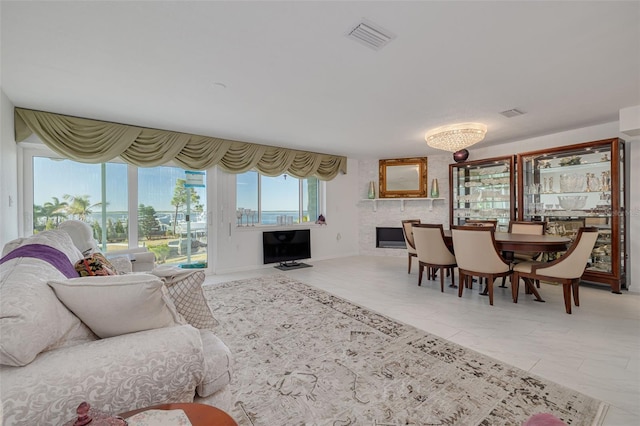 living area with visible vents and light tile patterned floors