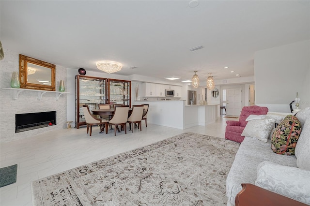 living area with a fireplace and visible vents