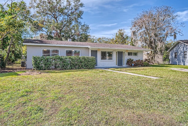 single story home with a front yard and cooling unit