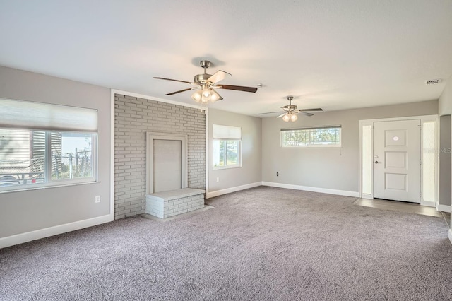 unfurnished living room featuring ceiling fan and carpet