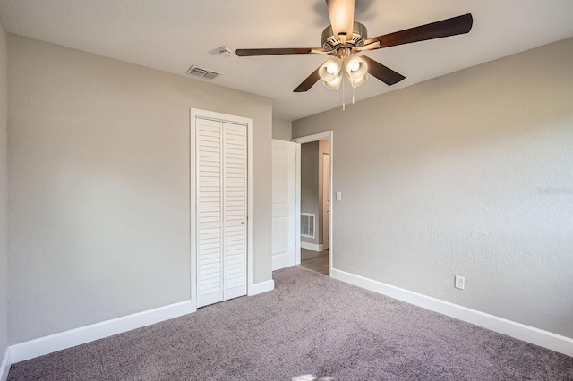 unfurnished bedroom with carpet, ceiling fan, and a closet