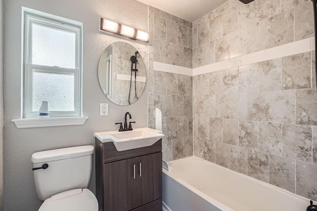 full bathroom featuring vanity, toilet, and tiled shower / bath