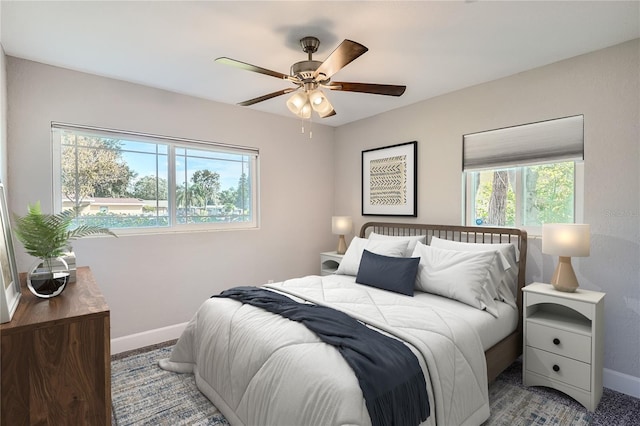 bedroom featuring ceiling fan and multiple windows