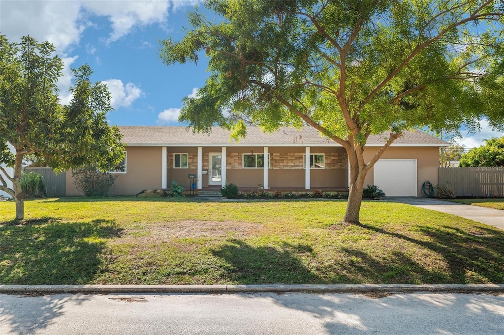 ranch-style house featuring a garage and a front yard