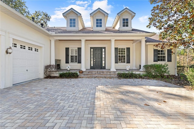 view of front of property with covered porch and a garage