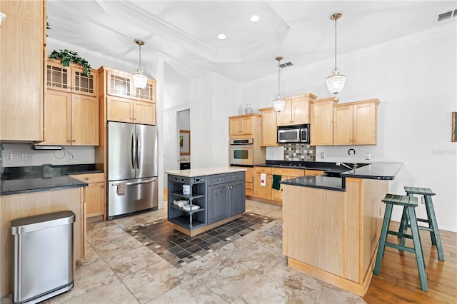 kitchen featuring hanging light fixtures, light brown cabinetry, a center island, and stainless steel appliances