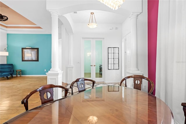 dining room featuring an inviting chandelier, light wood-type flooring, and french doors