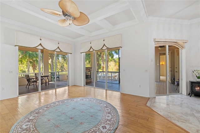 interior space with hardwood / wood-style floors, coffered ceiling, crown molding, ceiling fan, and beamed ceiling