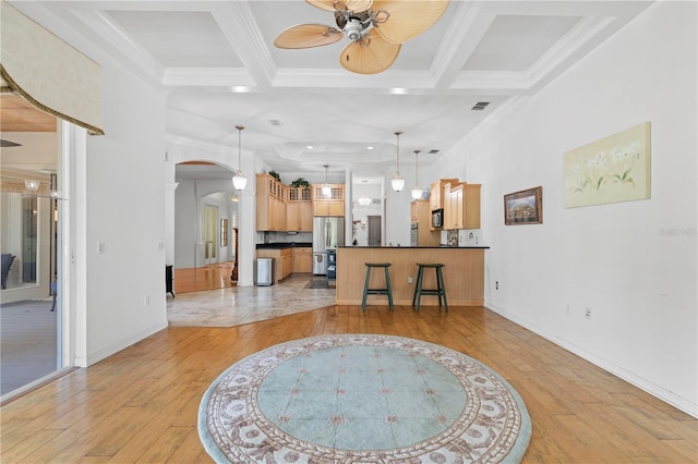 living room with beam ceiling, light hardwood / wood-style flooring, and coffered ceiling