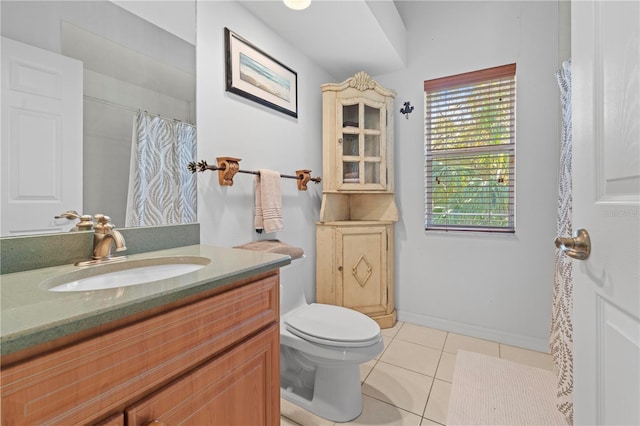 bathroom featuring tile patterned flooring, vanity, and toilet