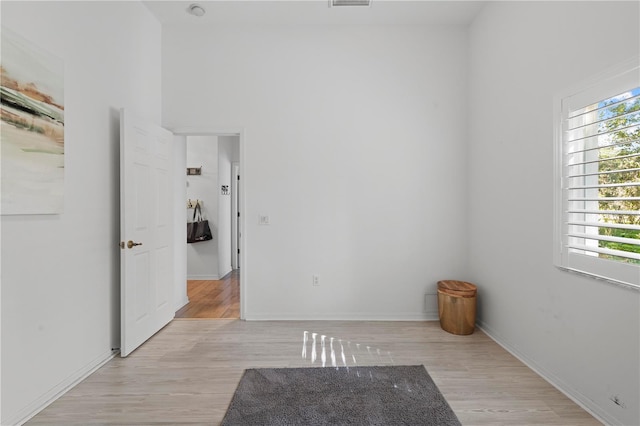 empty room featuring light wood-type flooring and a wealth of natural light