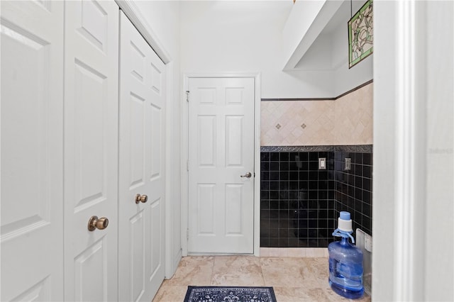 bathroom featuring tile patterned floors and tile walls