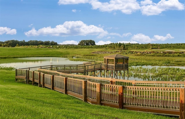 exterior space with a water view, a rural view, and a lawn