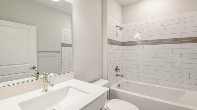 full bathroom with tiled shower / bath combo, vanity, and toilet