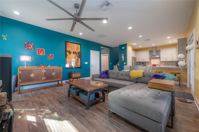 living room featuring dark hardwood / wood-style flooring and ceiling fan