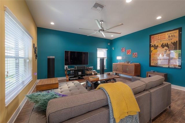 living room featuring dark hardwood / wood-style floors, ceiling fan, and a wealth of natural light