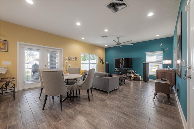 dining space with ceiling fan and dark hardwood / wood-style flooring