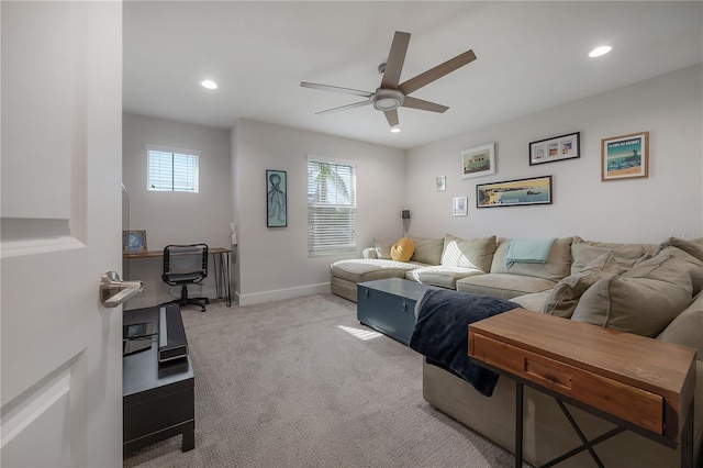 living room featuring ceiling fan and light colored carpet