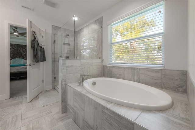 bathroom with tile patterned flooring, shower with separate bathtub, and a wealth of natural light