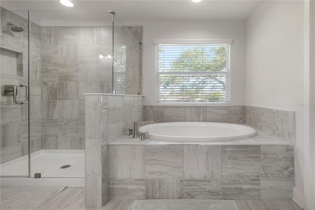 bathroom featuring separate shower and tub