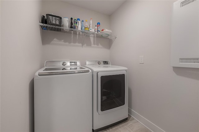 clothes washing area featuring independent washer and dryer