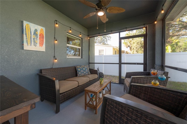 sunroom / solarium featuring ceiling fan