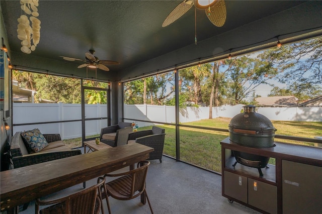 sunroom / solarium featuring ceiling fan