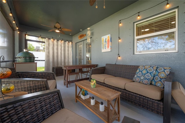 interior space featuring light carpet and ceiling fan