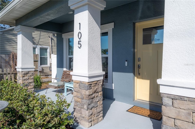 entrance to property featuring covered porch