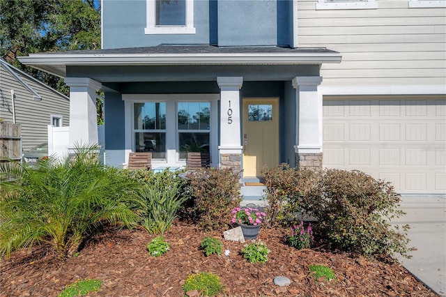 entrance to property featuring a porch and a garage