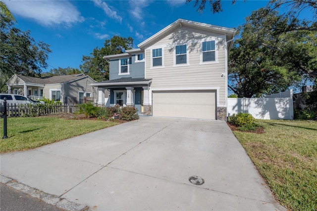 view of property featuring a front yard and a garage