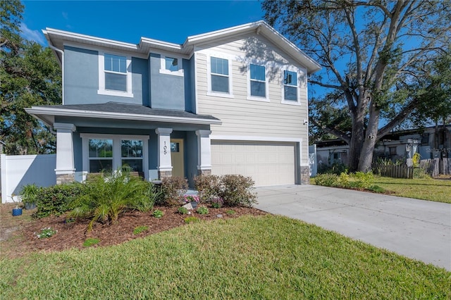 view of front of property featuring a front yard and a garage