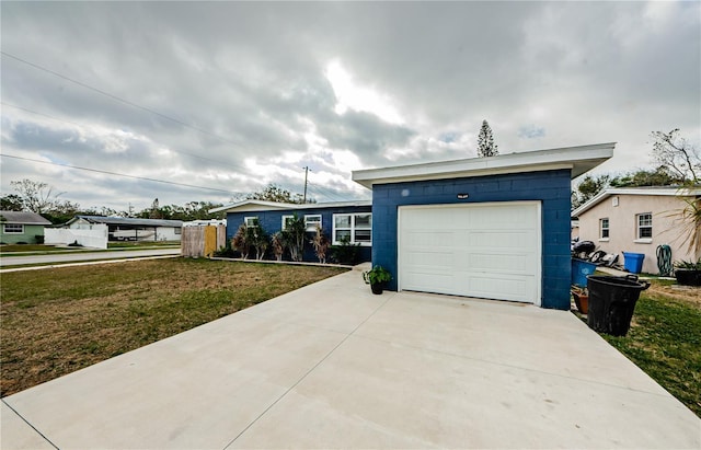 single story home featuring a front yard and a garage