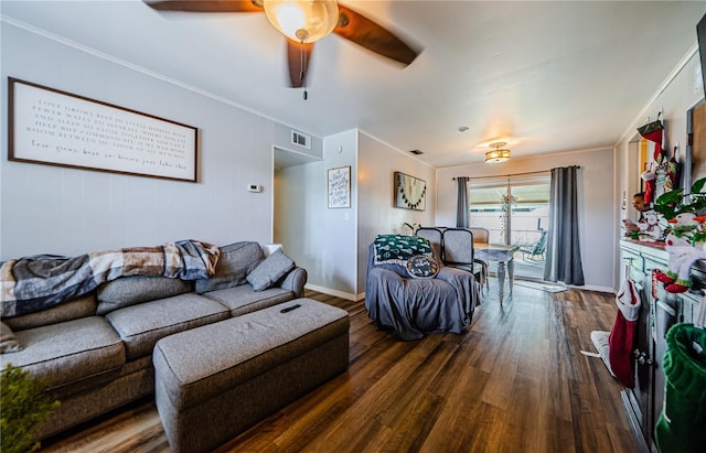 living room featuring dark hardwood / wood-style floors, ceiling fan, and crown molding