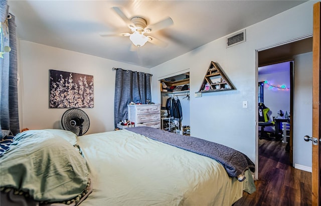 bedroom with ceiling fan, dark hardwood / wood-style flooring, and a closet